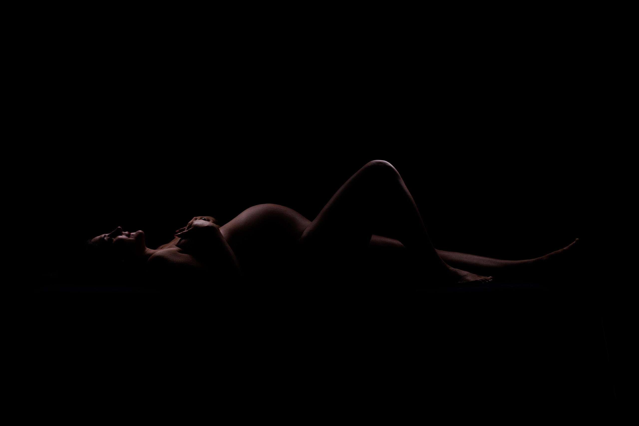 minimalist maternity portrait with soft textures and neutral tones
