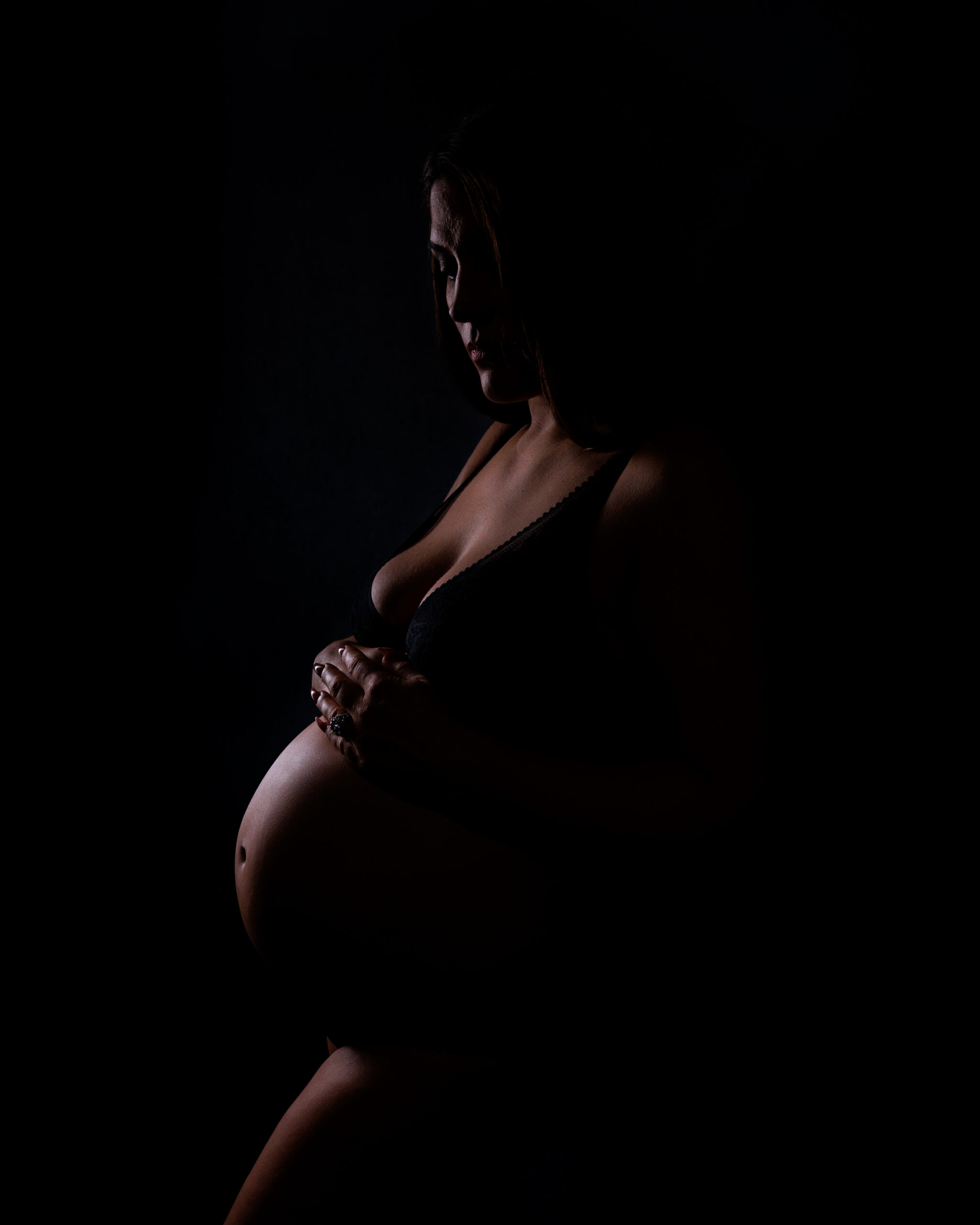 boudoir maternity side profile of pregnant woman highlighting curves