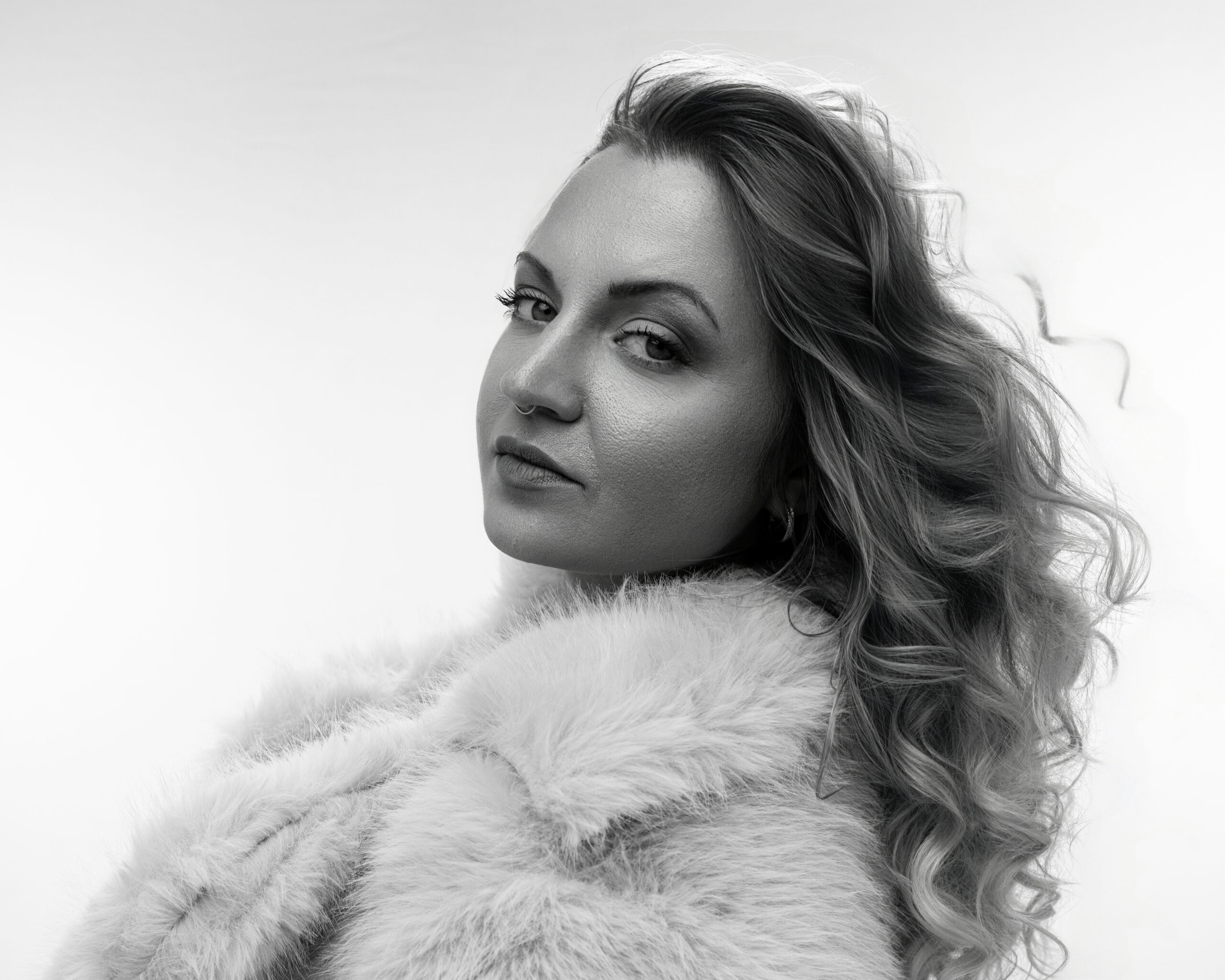 boudoir session in Indianapolis with soft glam portrait and fur wrap in studio