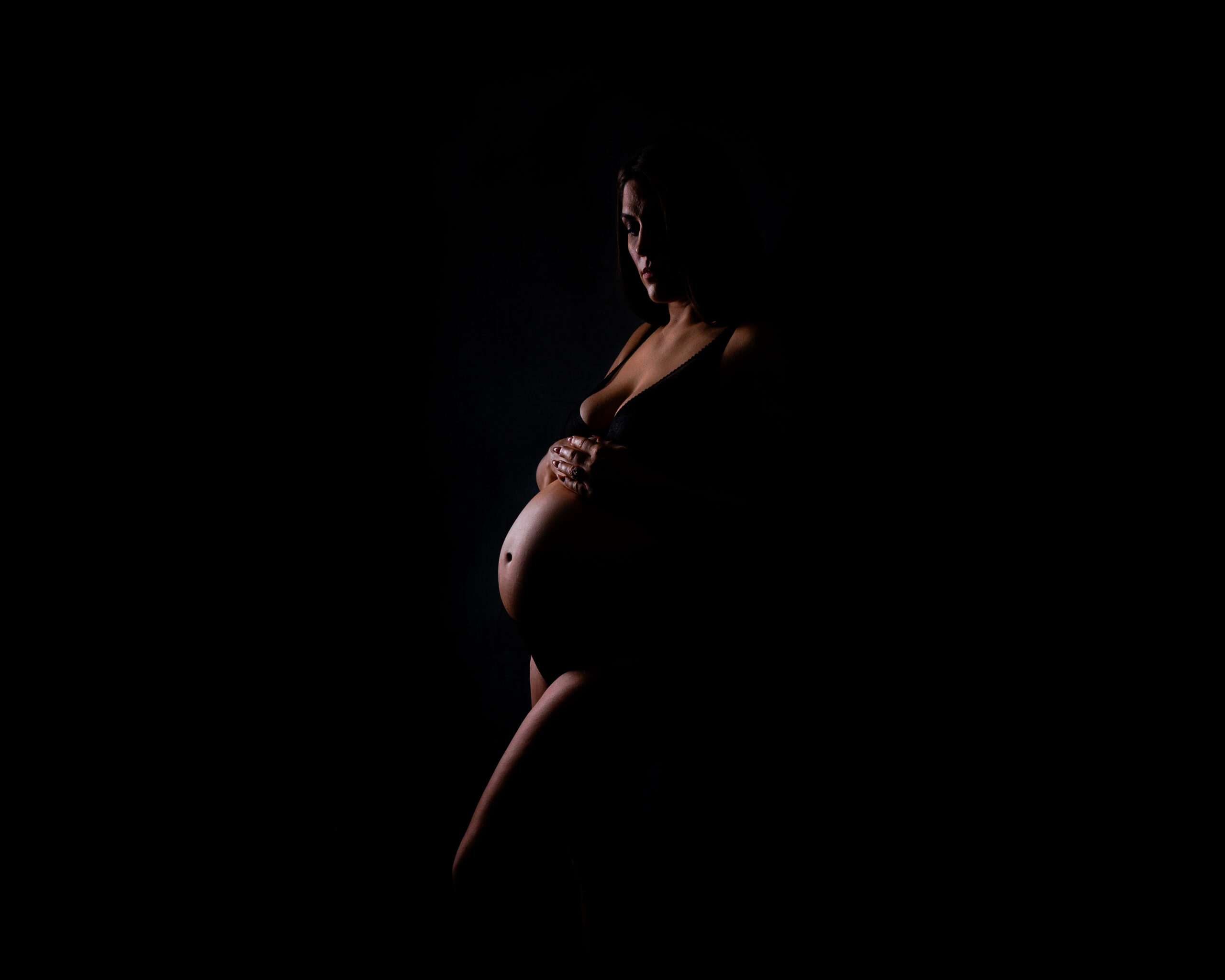 boudoir session maternity portrait in Indianapolis with soft dramatic lighting