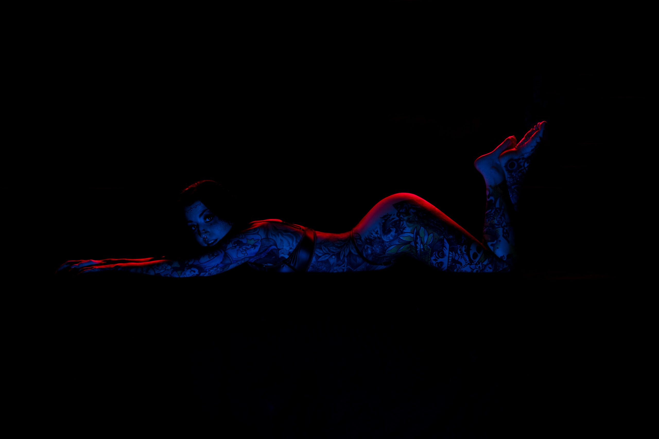 female empowerment photography in studio with red and blue creative lighting