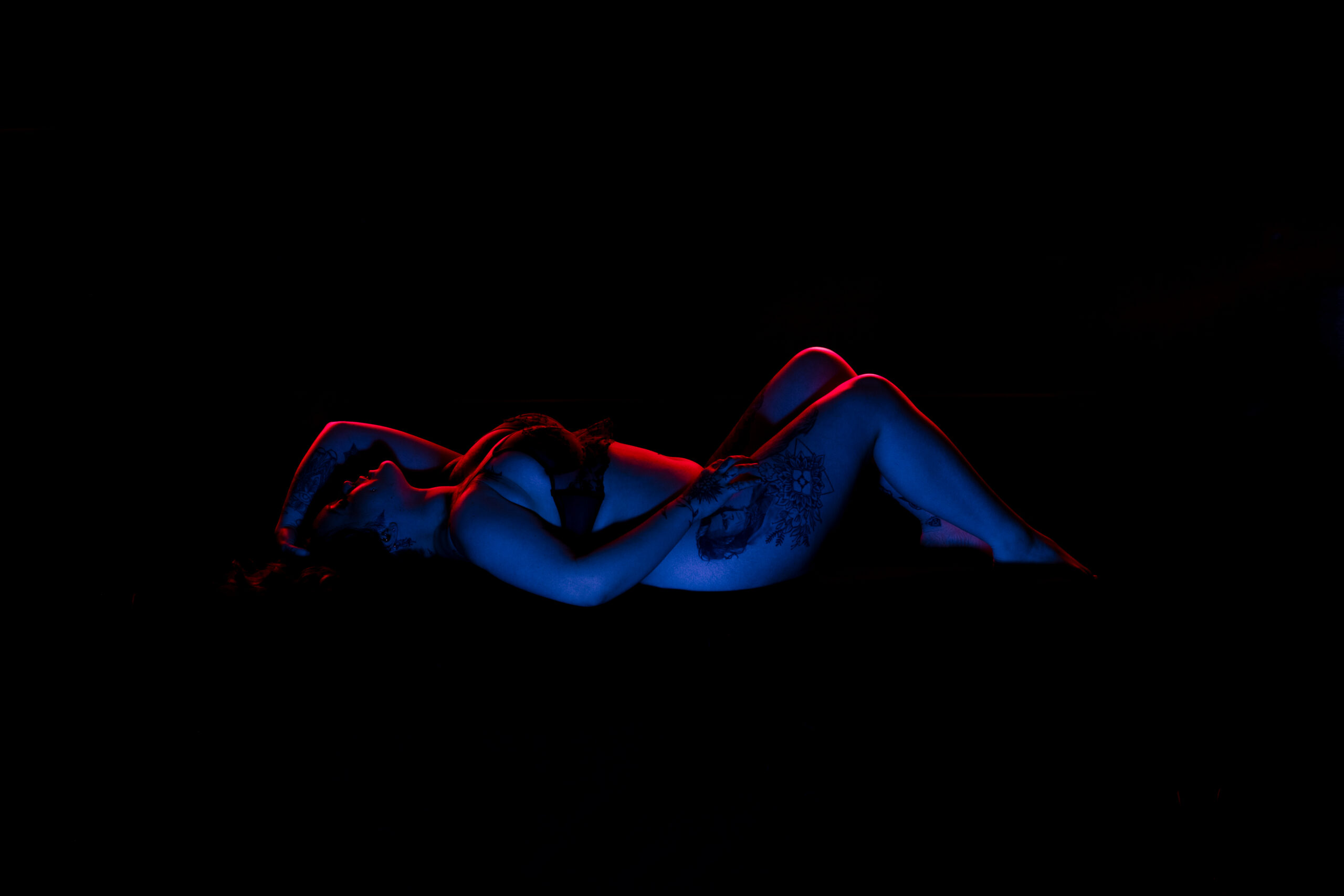 artistic boudoir studio near me with neon lighting and tattoo detail