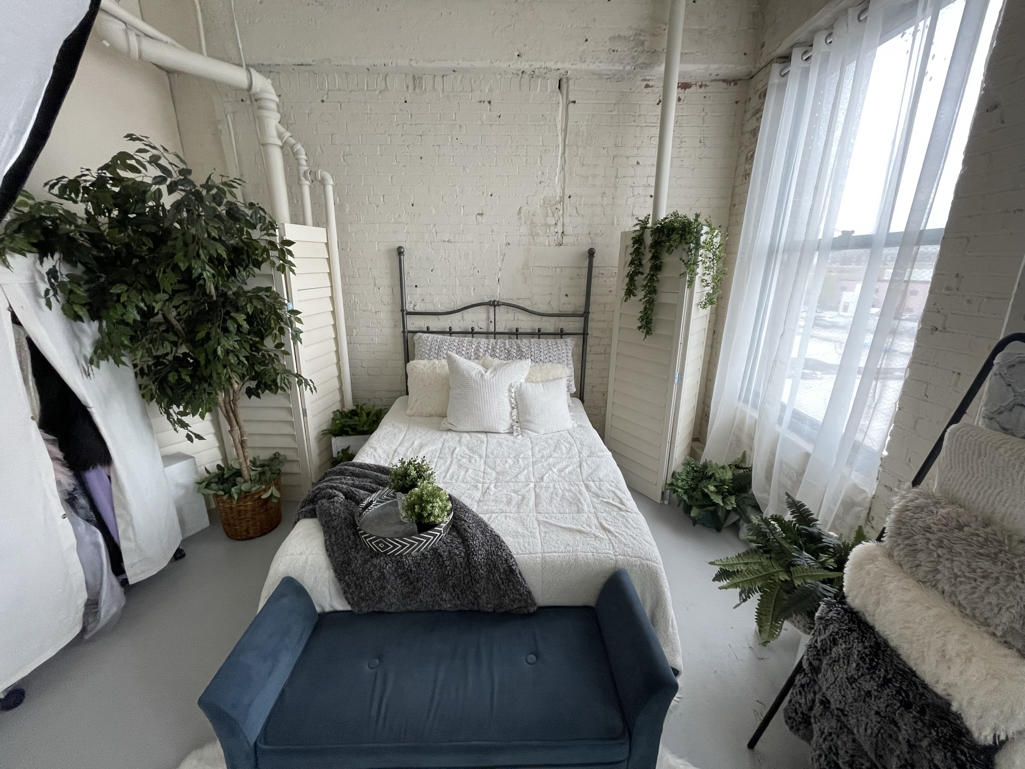 boudoir photography in studio with cozy bed and neutral styling