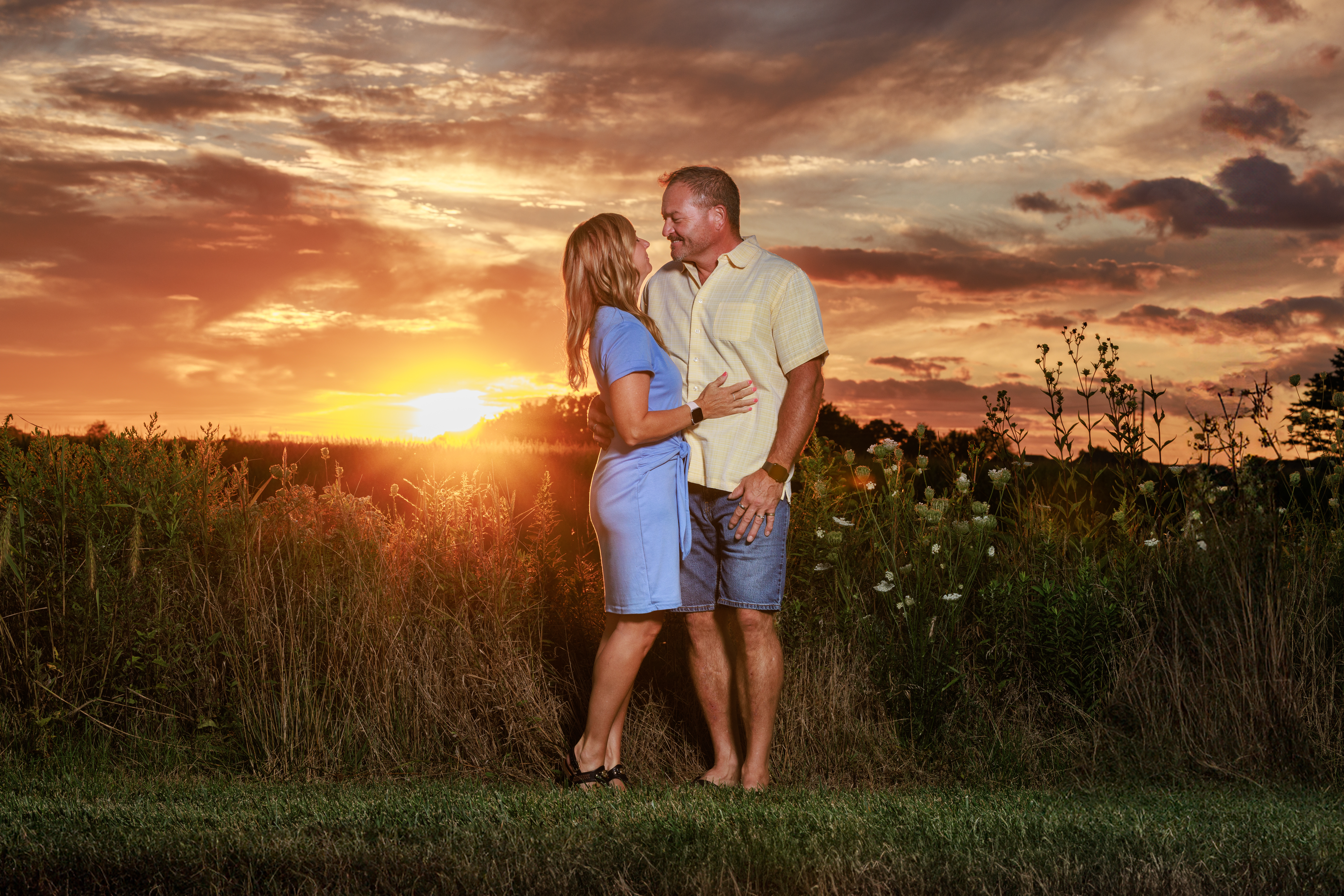 Couple in an embrace while the sunsets at Flat Fork Creek, a top family photo location in Indianapolis