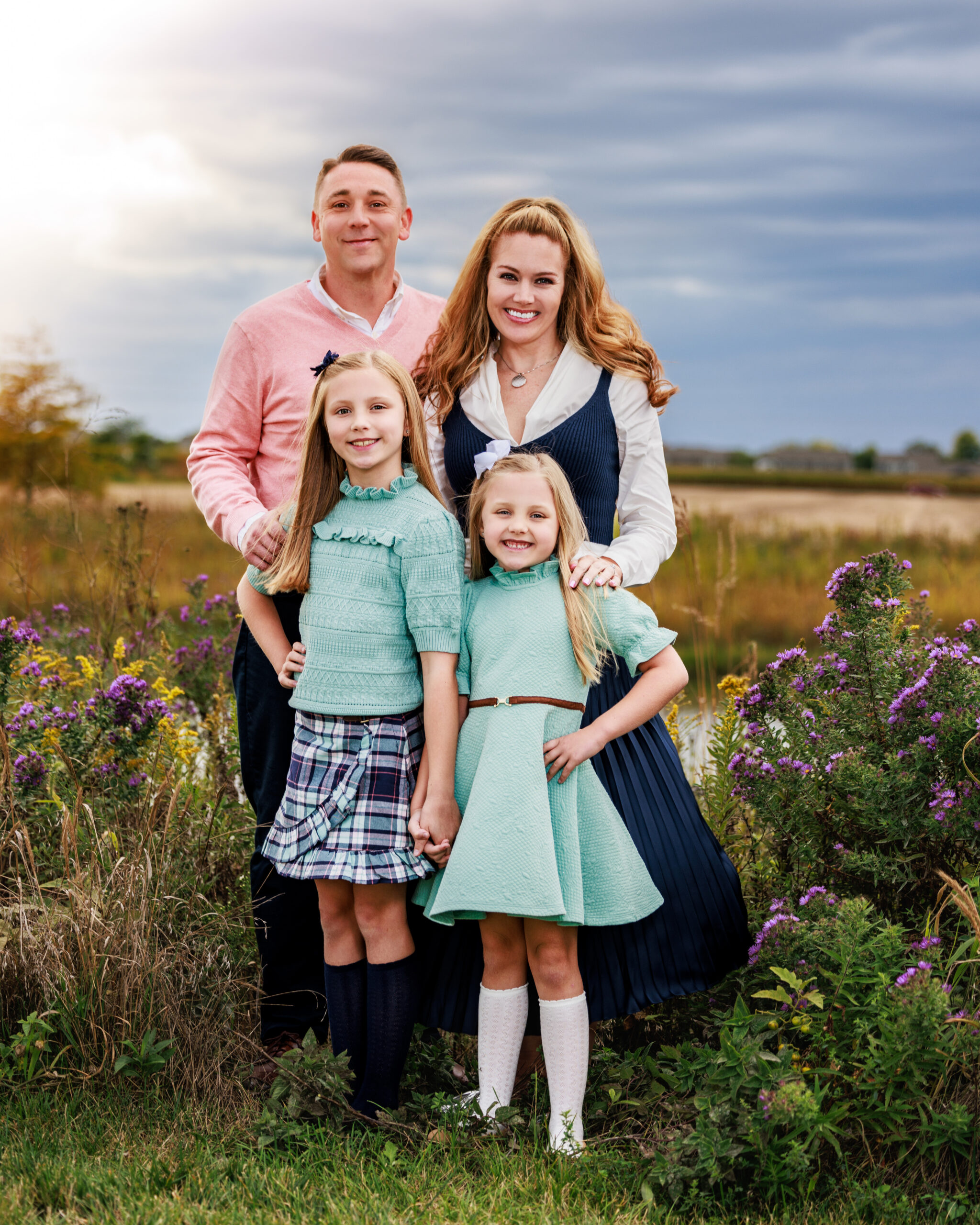 Family standing and smiling at Flat Fork Creek Park, a top family photo location in Indianapolis
