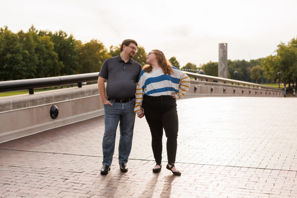 A couple poses on a bridge on the Canal, a top family photo location in Indianapolis