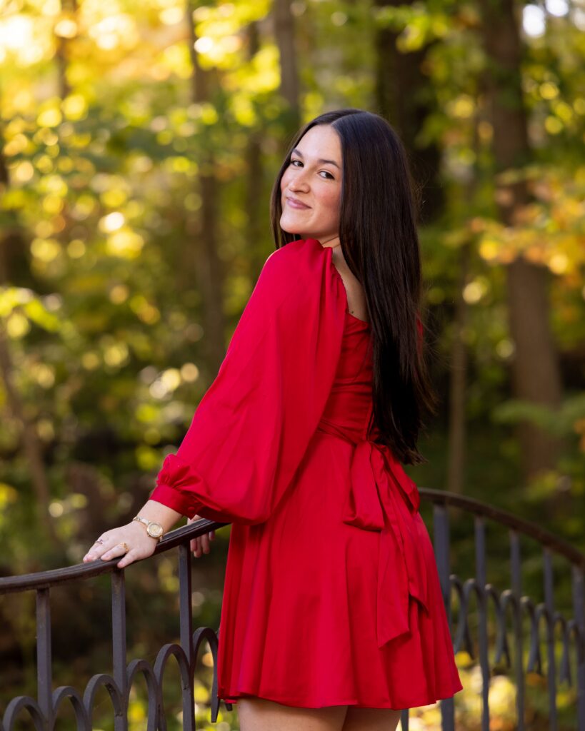 Indianapolis senior photographer captures outdoor portrait of graduate near fountain and fall foliage