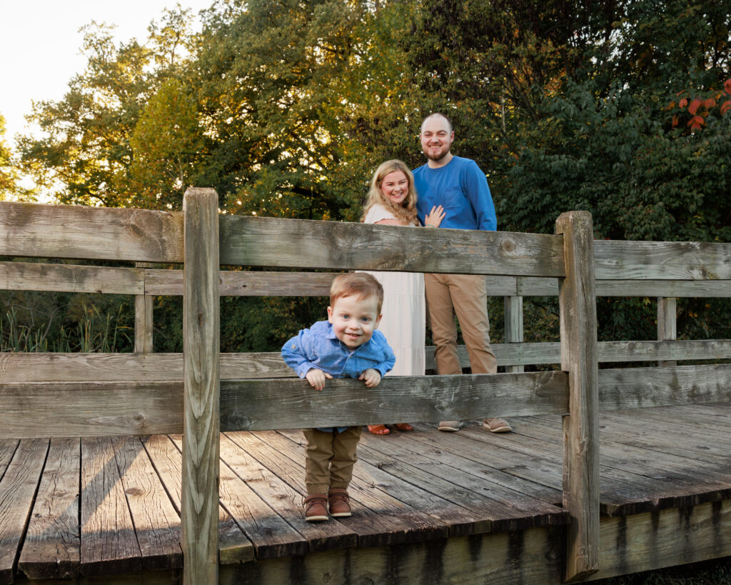 Family portrait on a wood bridge at Fort Harrison State Park, a top family photo location in Indianapolis