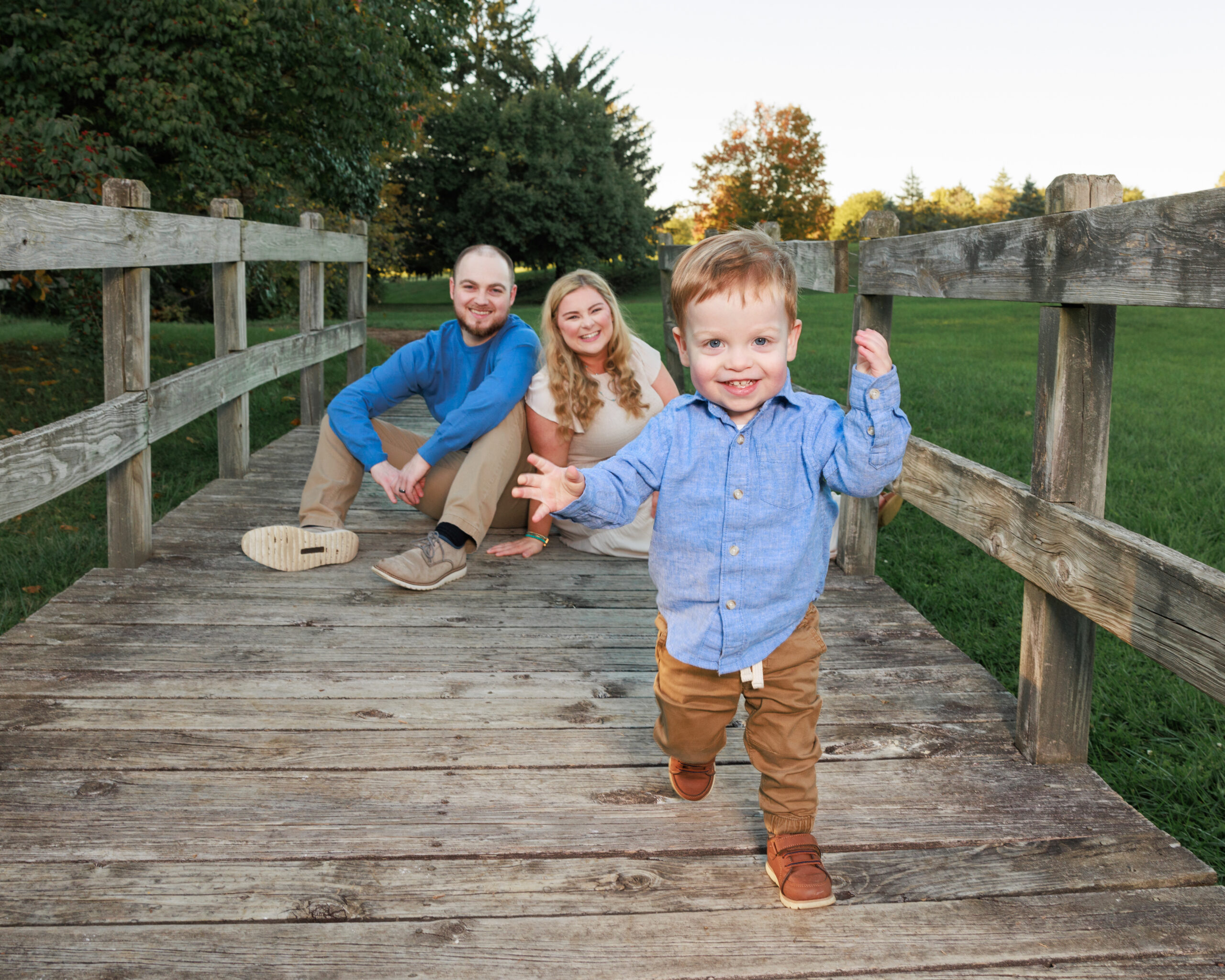Family portrait on a wood bridge at Fort Harrison State Park