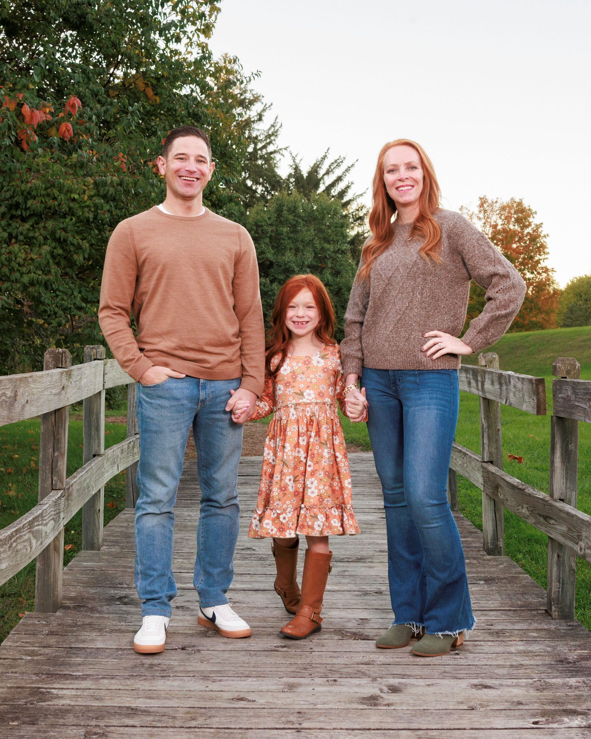 Family portrait on a wood bridge at Fort Harrison State Park