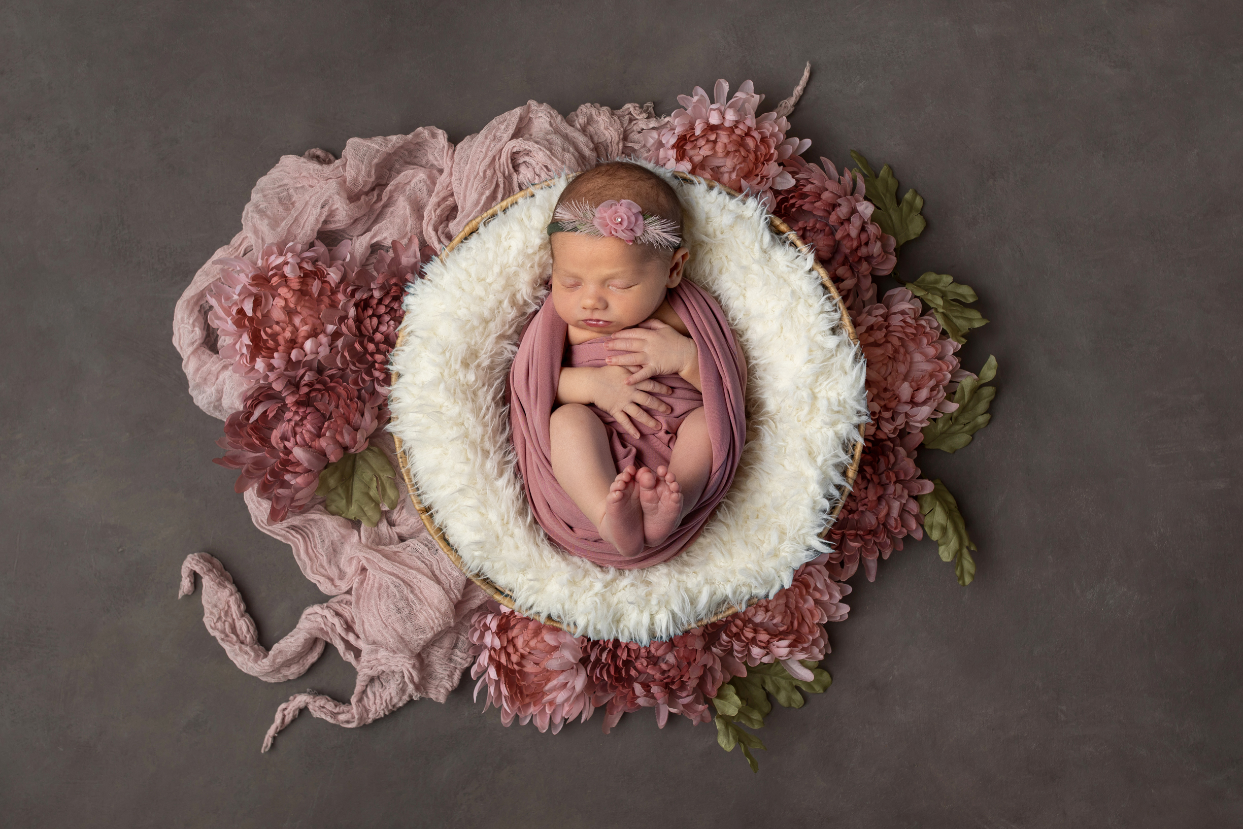 Newborn baby with floral headband, grow with me photography package newborn session