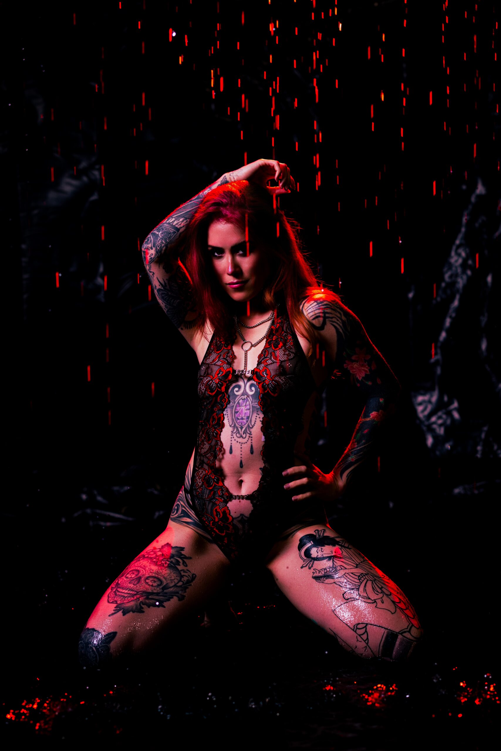 Pink and magenta lighting with falling water at Embrace Boudoir's rain room