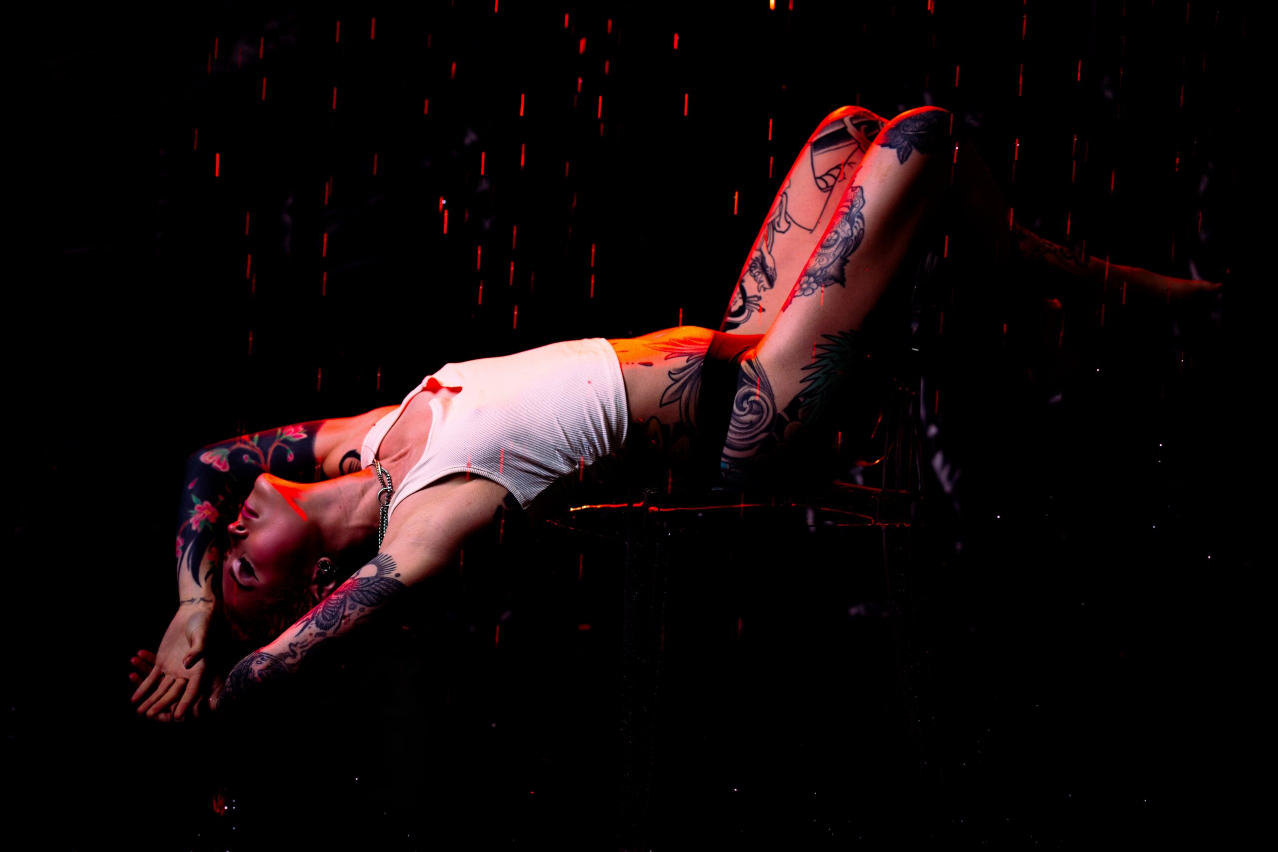 Falling water and warm golden lighting in the Embrace Boudoir rain room