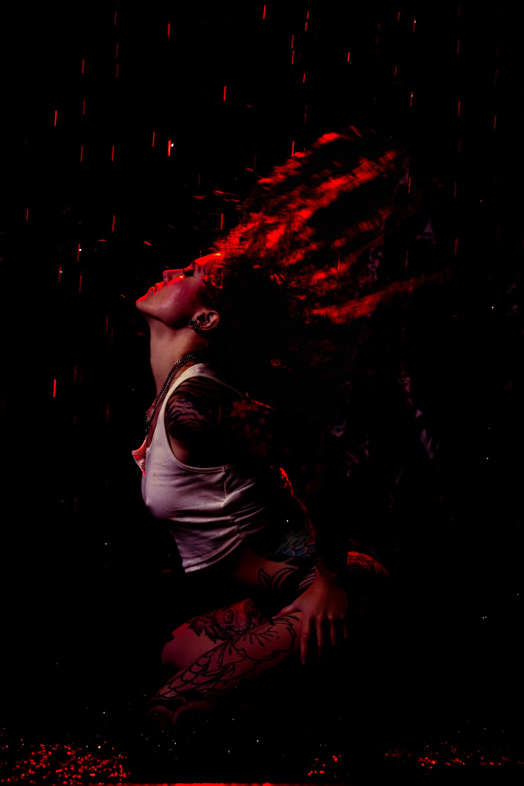 Blue-toned lighting and rain effect inside the Embrace Boudoir rain room set