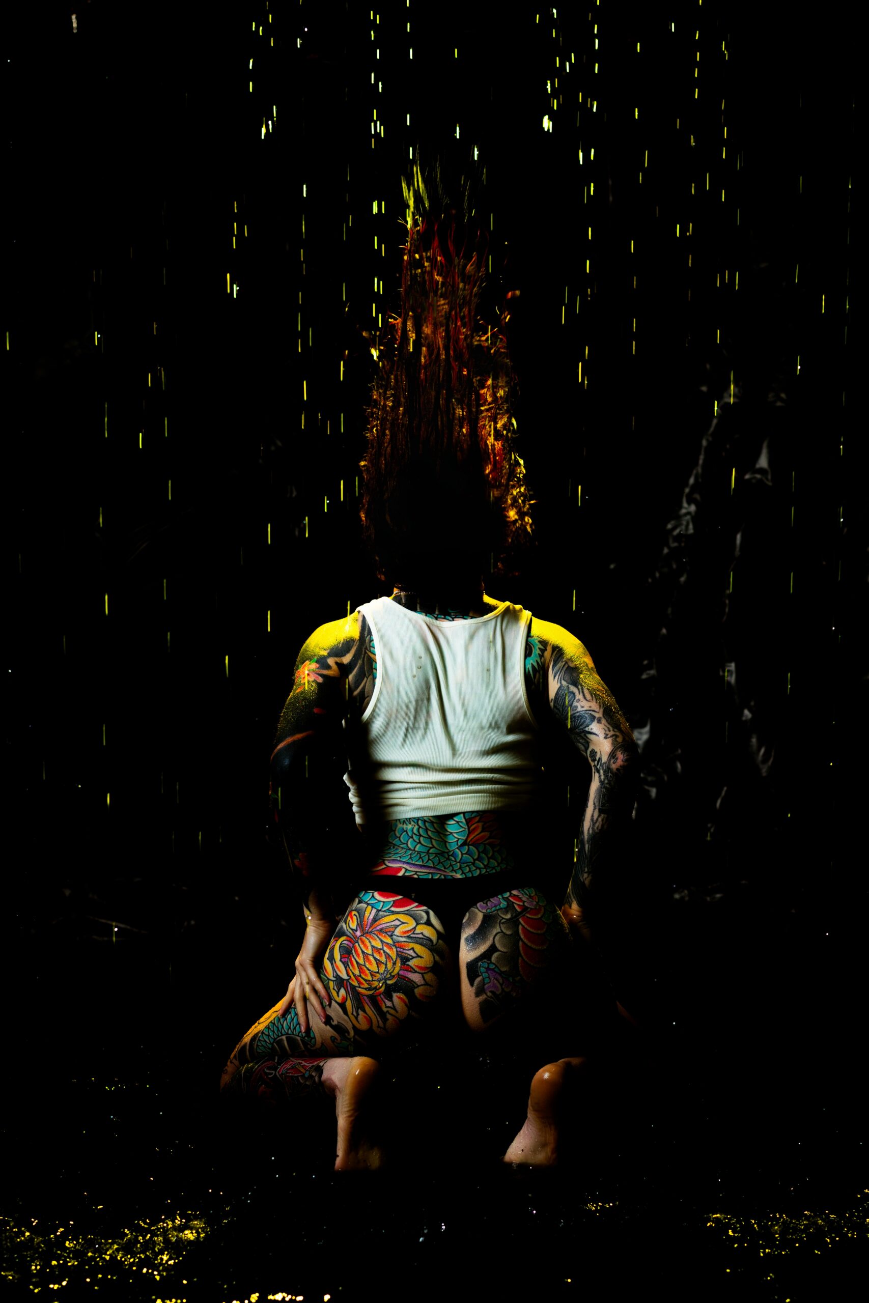 Warm amber lighting through falling water in the rain room great for boudoir photo shoot ideas