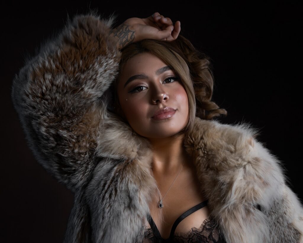 Dramatic, low-key lighting against a solid black studio backdrop