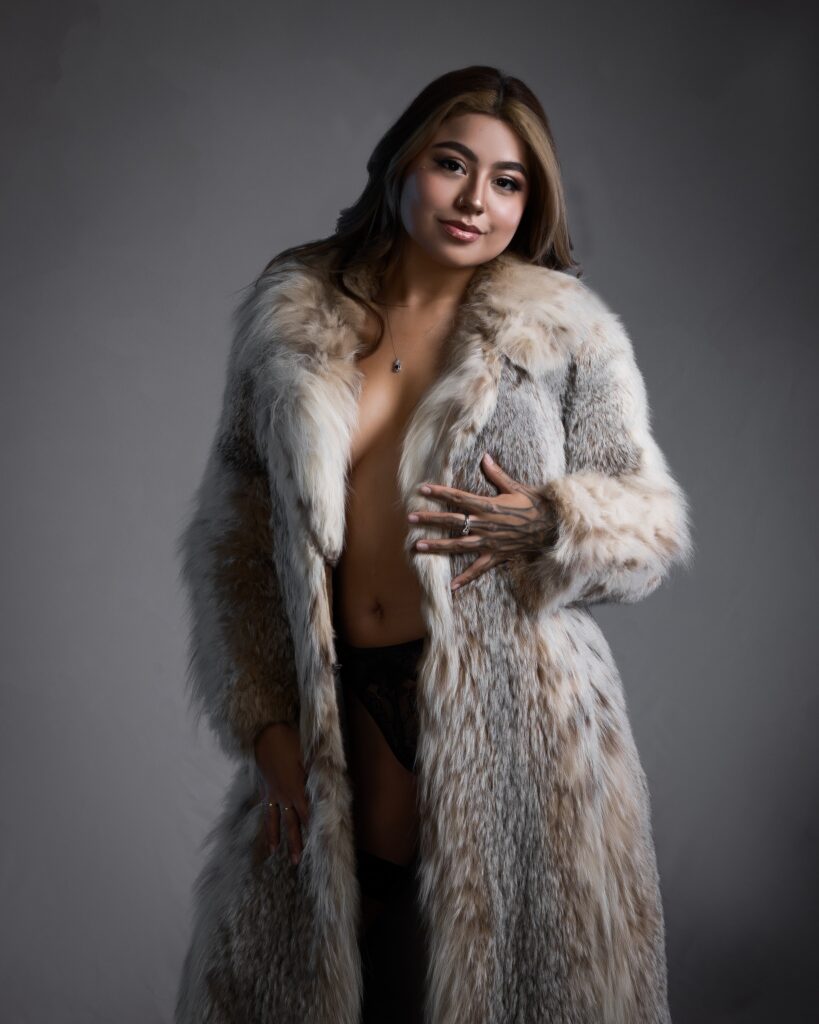 Soft, moody lighting against a neutral gray studio backdrop for this boudoir photoshoot outfits feature